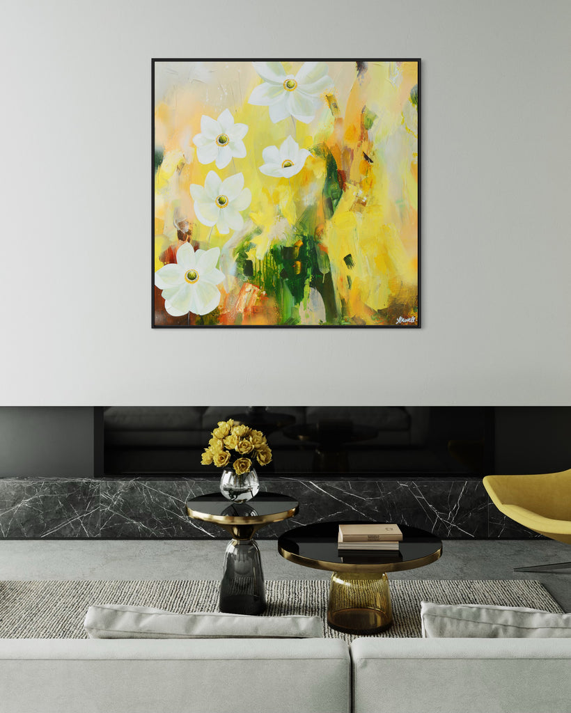 A 'Fresh Start' original acrylic painting by Jasmine Marshall framed in black/oak. Canvas painting features white anemone flowers atop cream, lime green, yellow, and brown abstract details, featured in a neutral home interior with yellow roses..