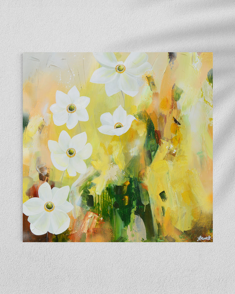 A 'Fresh Start' original acrylic painting by Jasmine Marshall framed in black/oak. Canvas painting features white anemone flowers atop cream, lime green, yellow, and brown abstract details, featured in a gallery..