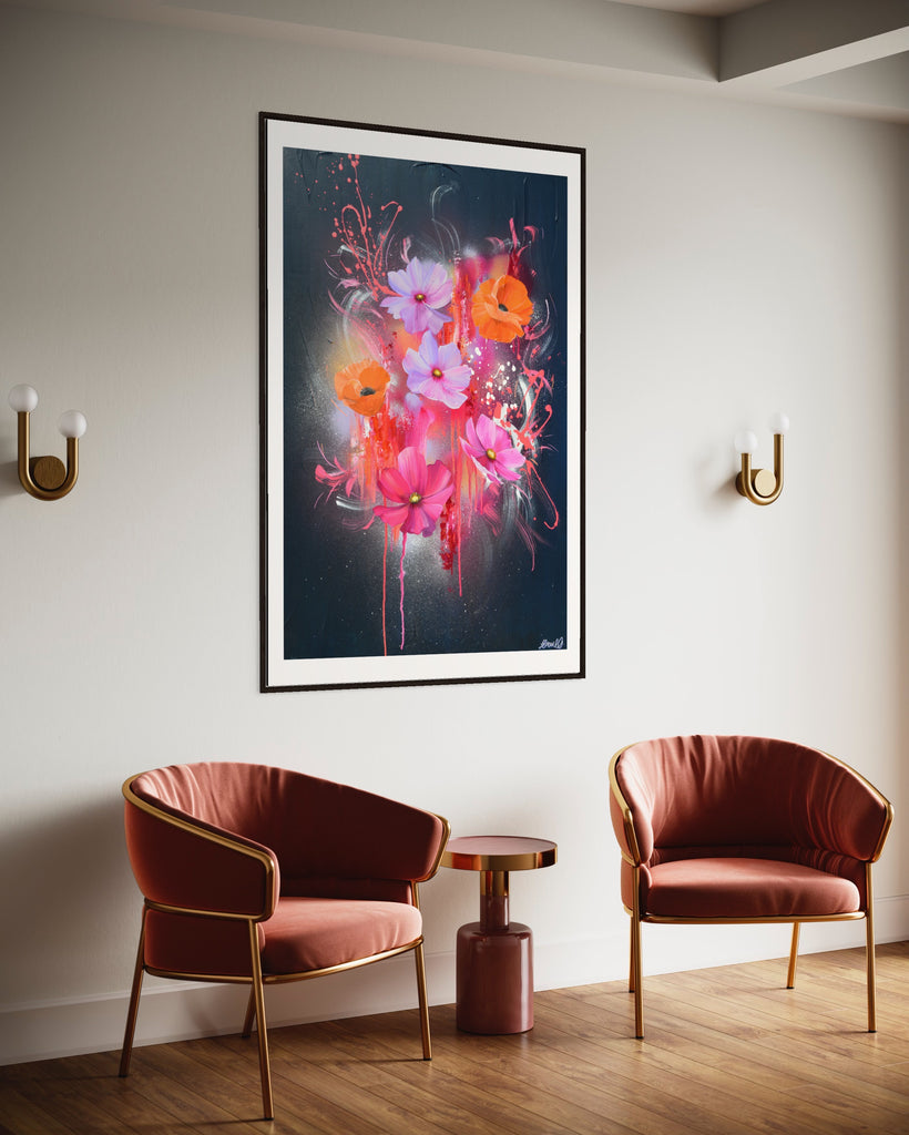 A 'Drama Tropicana' Fine Art Print by Jasmine Marshall, framed in black/oak. Premium Giclée print features white orange poppies and pink and purple flower on an abstract navy background, featured in a neutral home interior with pink leather chairs.