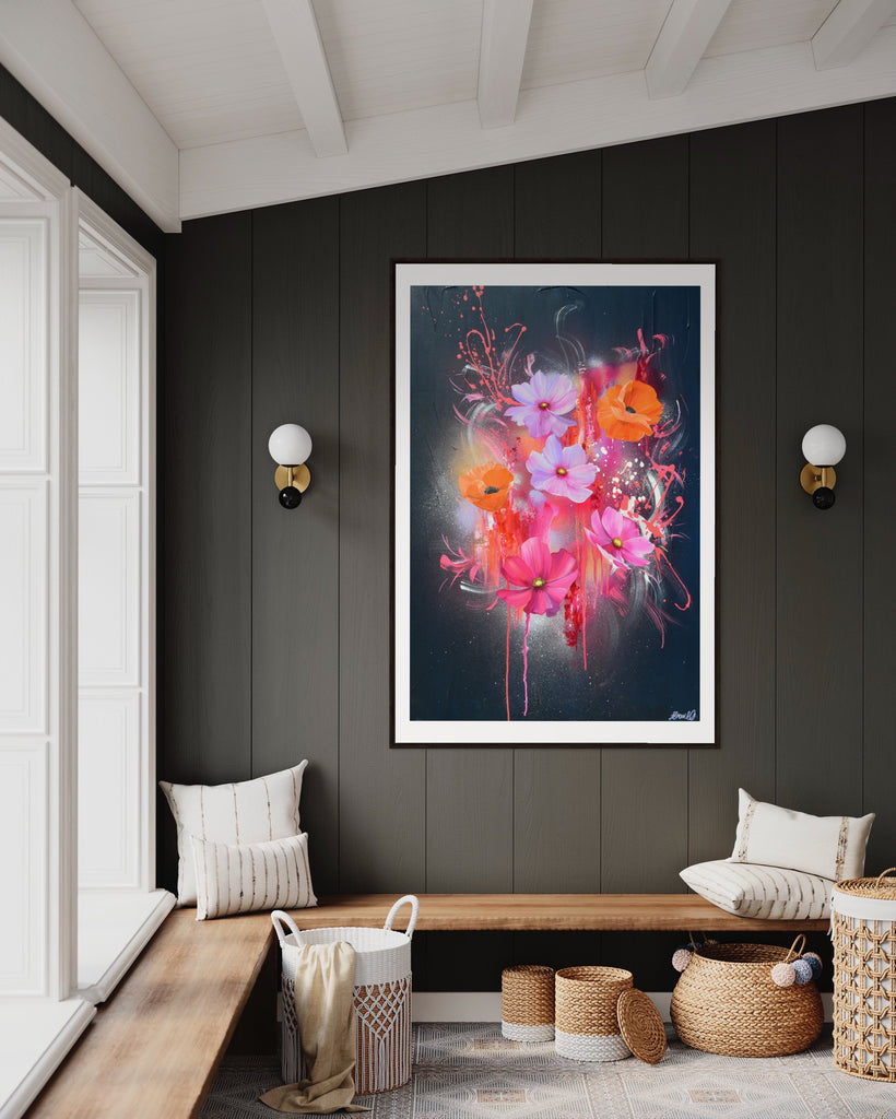 A 'Drama Tropicana' Fine Art Print by Jasmine Marshall, framed in black/oak. Premium Giclée print features white orange poppies and pink and purple flower on an abstract navy background, featured in a neutral home interior on grey wood.