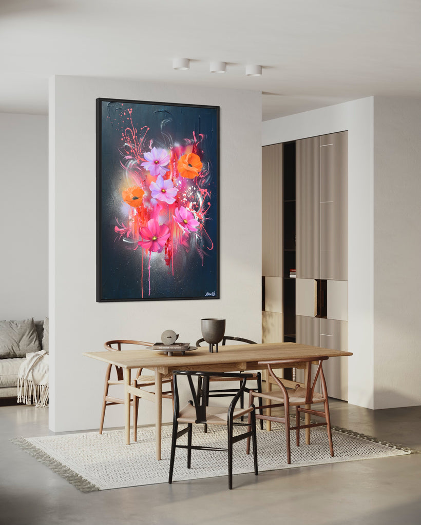 'Drama Tropicana' original painting on a cotton canvas by Jasmine Marshall, framed in black/oak. Features orange poppies and pink and purple flower on an abstract navy background and neon pink, featured in a neutral kitchen and wooden kitchen table.