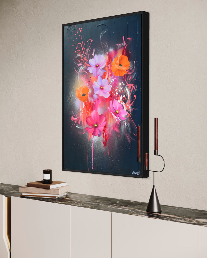 'Drama Tropicana' original painting on a cotton canvas by Jasmine Marshall, framed in black/oak. Features orange poppies and pink and purple flower on an abstract navy background, featured in a neutral home interior with candles and books.