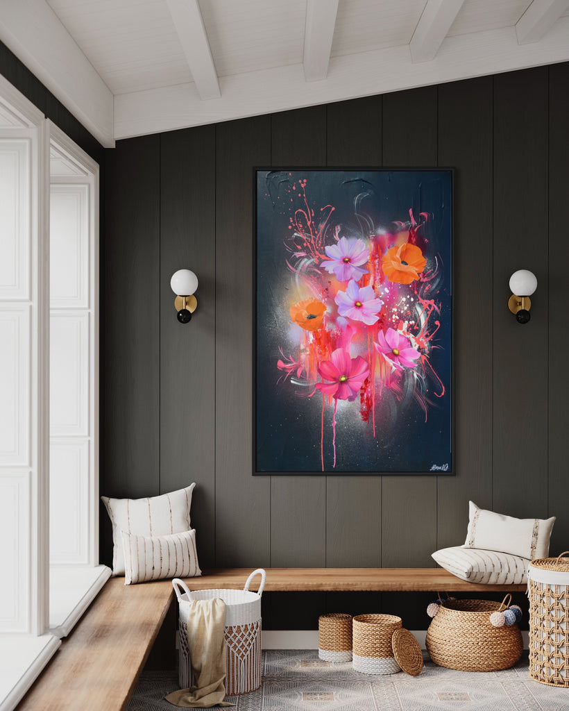 'Drama Tropicana' original painting on a cotton canvas by Jasmine Marshall, framed in black/oak. Features orange poppies and pink and purple flower on an abstract navy background, featured in a neutral home interior on a grey wooden wall.