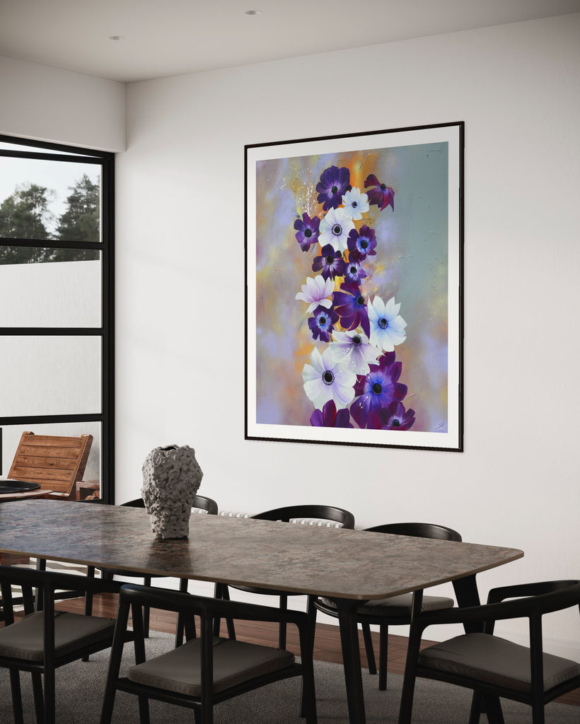 ‘Flourish' Fine Art Print by Jasmine Marshall, framed in black/oak. Premium Giclée print features white and purple anemone flowers on a grey and lilac abstract background, featured in a neutral home interior with glass doors and black dining table.