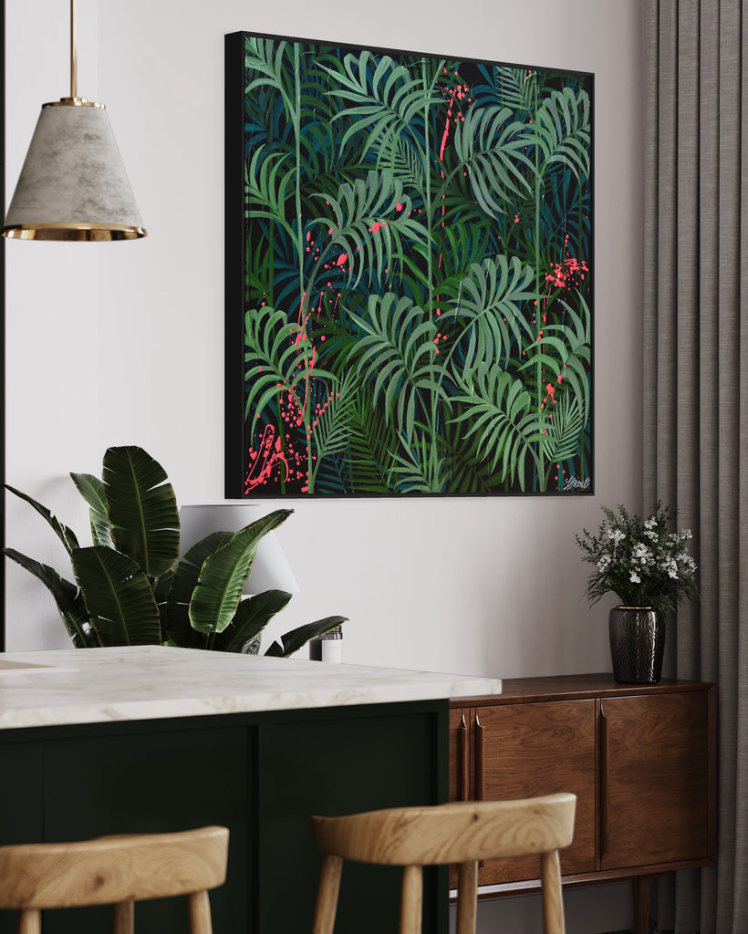 'Forever Green' original painting on a cotton canvas by Jasmine Marshall, framed in black/oak. Features layers of palm leaves on a black background with pops on neon pink.  Displayed in a green kitchen with plants..