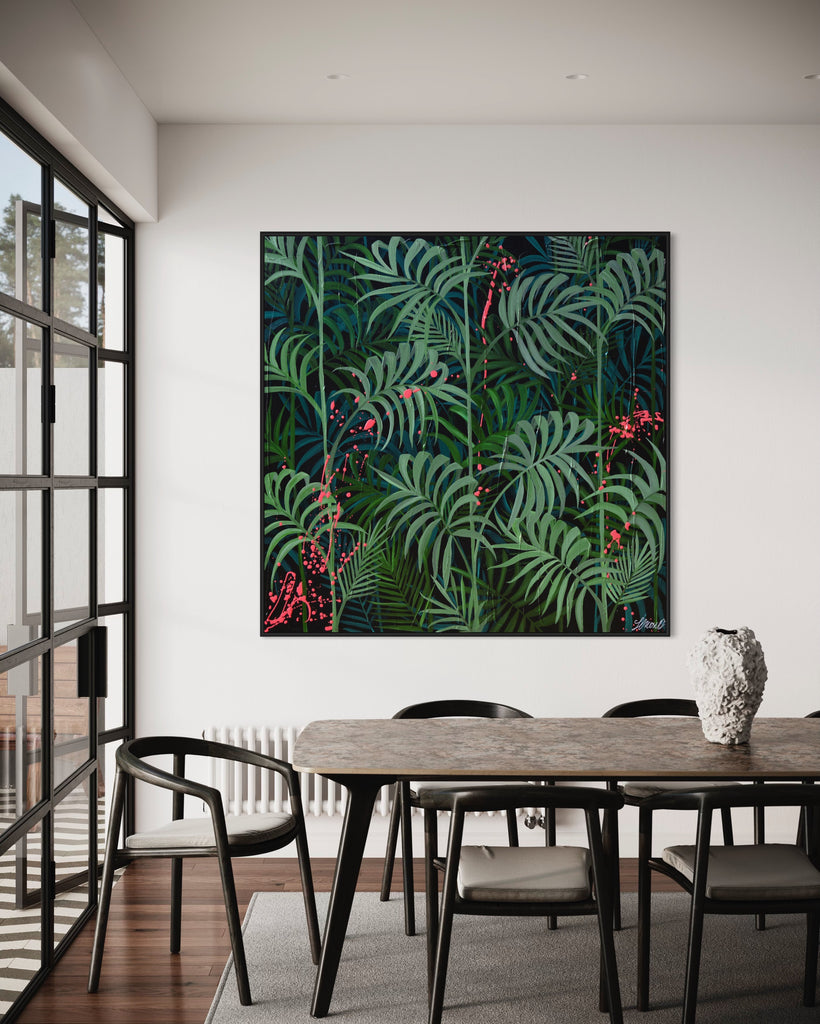 'Forever Green' original painting on a cotton canvas by Jasmine Marshall, framed in black/oak. Features layers of palm leaves on a black background with pops on neon pink.  Displayed in a dining room with black table..