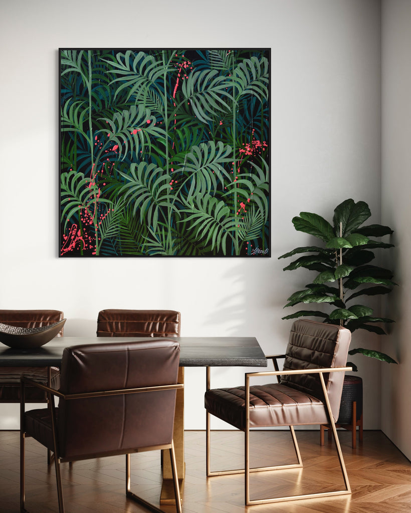 'Forever Green' original painting on a cotton canvas by Jasmine Marshall, framed in black/oak. Features layers of palm leaves on a black background with pops on neon pink.  Displayed in a kitchen with a wooden brown dining table..