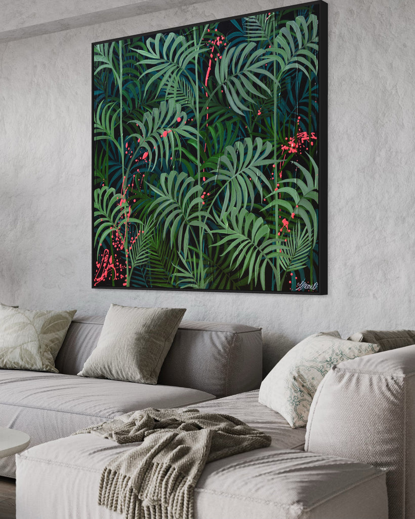 'Forever Green' original painting on a cotton canvas by Jasmine Marshall, framed in black/oak. Features layers of palm leaves on a black background with pops on neon pink.  Displayed in a neutral home interior.with a grey sofa and blanket.