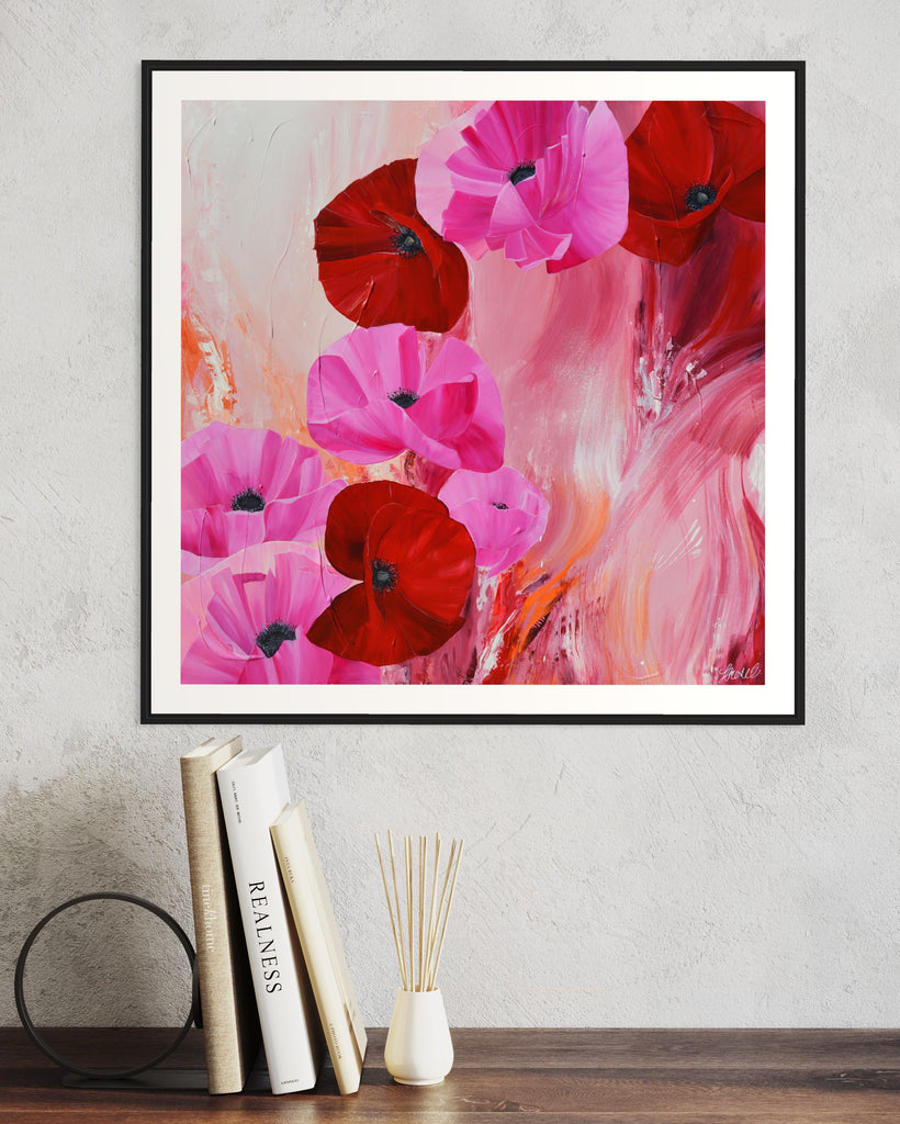 ‘It’s a Forever Thing' Fine Art Print by Jasmine Marshall, framed in black/oak. Premium Giclée print features pink and red poppies on an abstract background with pops of orange.  Displayed in a neutral home interior above a bookshelf.