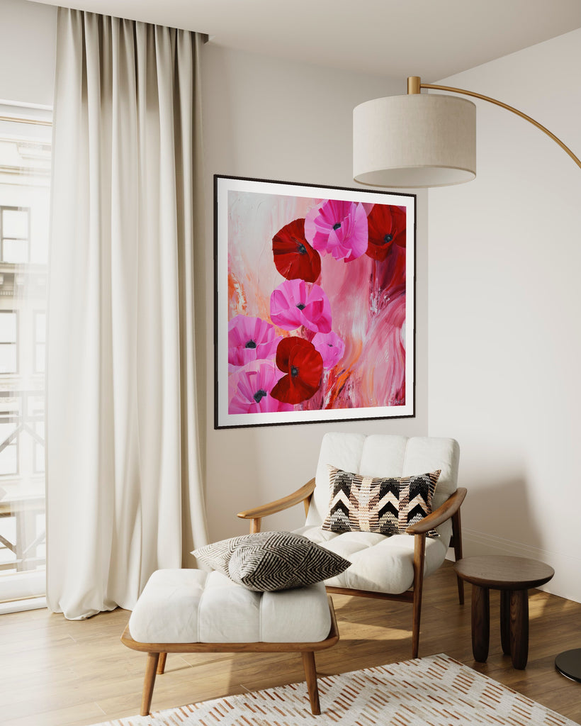 ‘It’s a Forever Thing' Fine Art Print by Jasmine Marshall, framed in black/oak. Premium Giclée print features pink and red poppies on an abstract background with pops of orange.  Displayed in a neutral home interior with a white chair, white curtains and lamp.