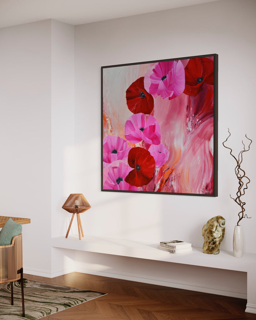 'It’s a Forever Thing' original painting on a cotton canvas by Jasmine Marshall, framed in black/oak. Features pink and red poppies on an abstract background with pops of orange. Displayed in a neutral home interior.