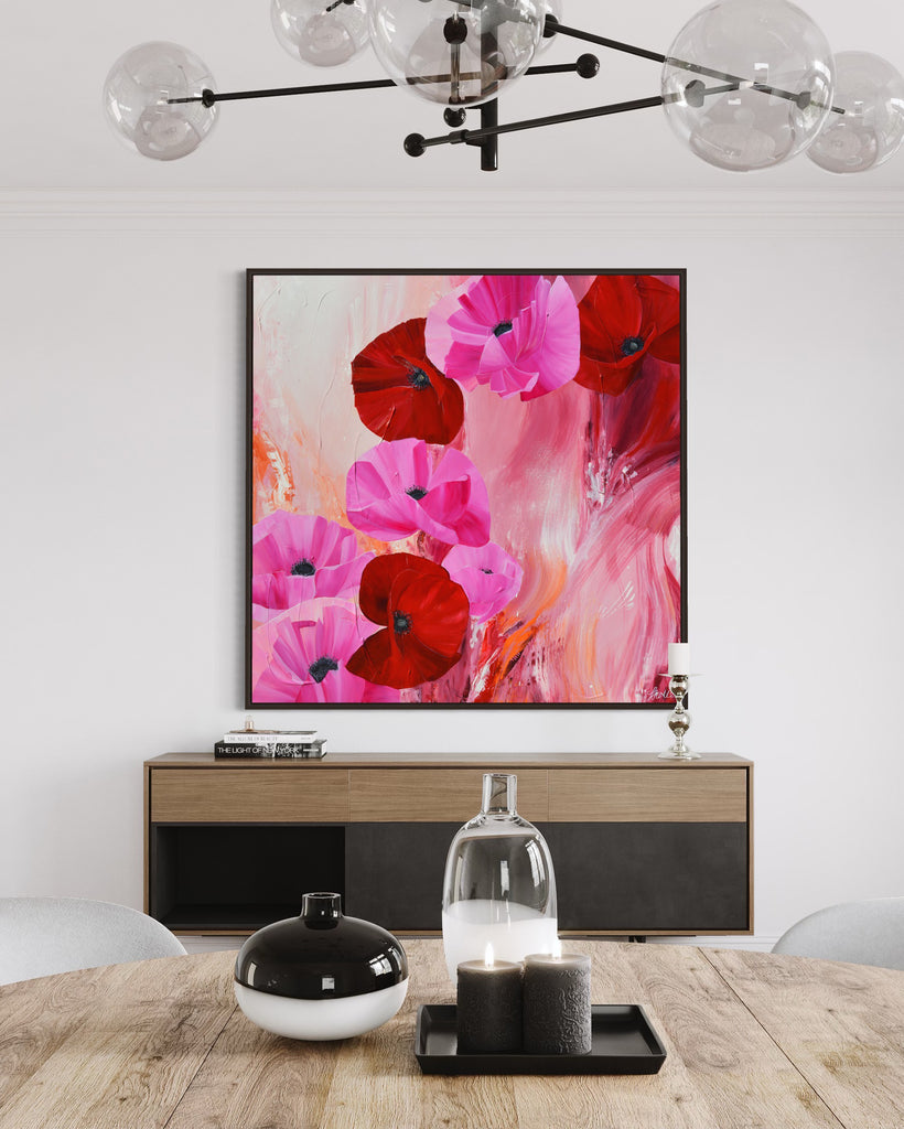 'It’s a Forever Thing' original painting on a cotton canvas by Jasmine Marshall, framed in black/oak. Features pink and red poppies on an abstract background with pops of orange. Displayed in a neutral home interior.