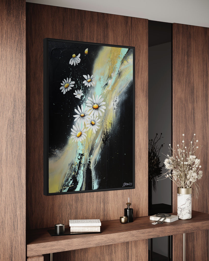 'Light in the Darkness' original painting on a cotton canvas by Jasmine Marshall, framed in black/oak. Features white daisies on a black abstract background. Displayed on a wooden wall with dried flowers.