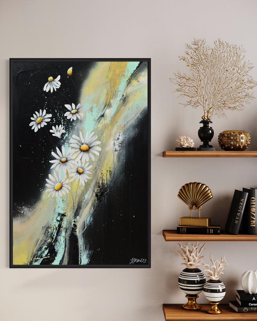 'Light in the Darkness' original painting on a cotton canvas by Jasmine Marshall, framed in black/oak. Features white daisies on a black abstract background. Displayed in a neutral home interior with black and brown shelves.