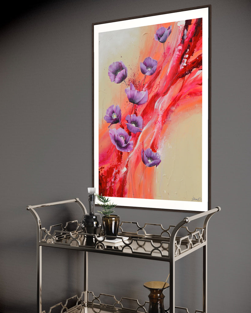 ‘Making Memories' Fine Art Print by Jasmine Marshall, framed in black/oak. Premium Giclée print features purple poppies on a cream and red abstract background.  Displayed on a dark grey wall with a metal bar cart. 