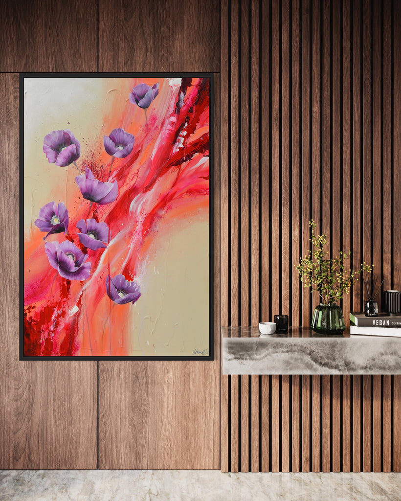 'Making Memories' original painting on a cotton canvas by Jasmine Marshall, framed in black/oak. Features purple poppies on a cream and red abstract background. Displayed on a wooden wall..