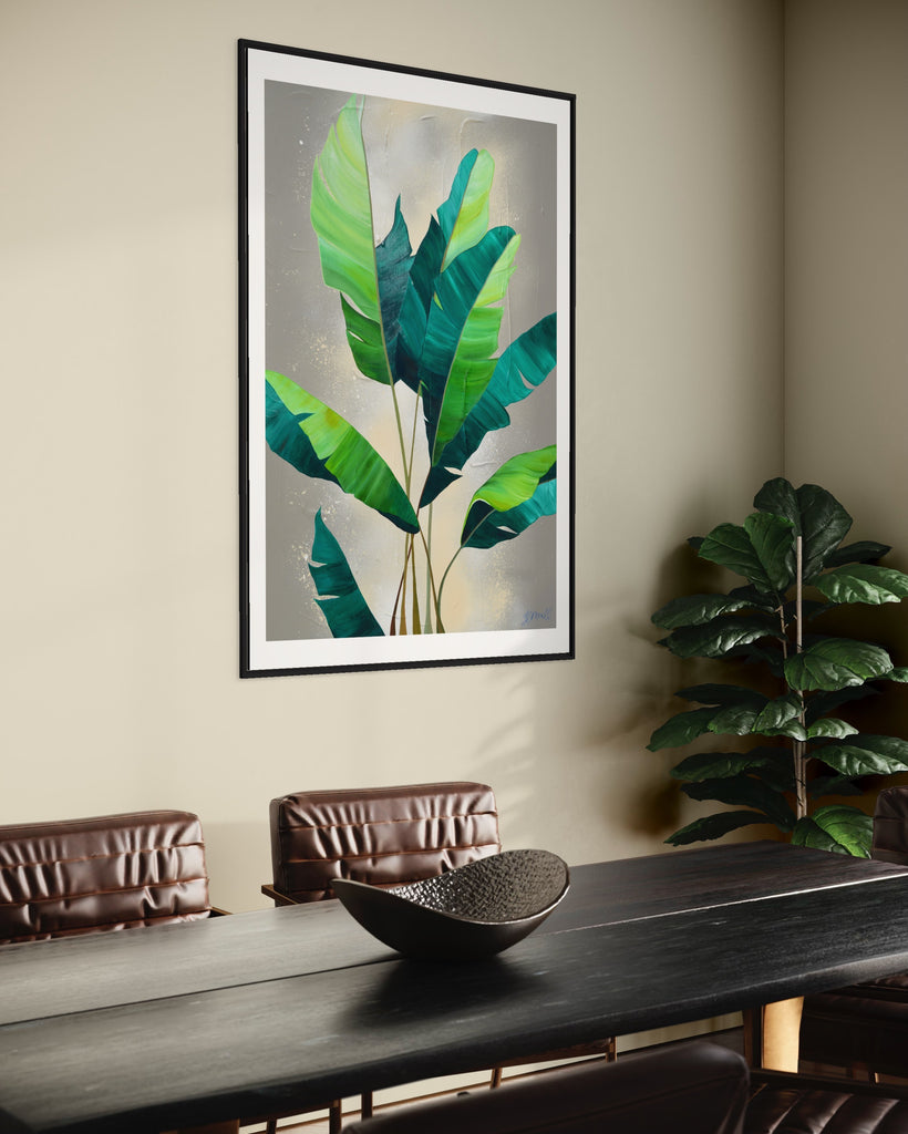 ‘Rainforest Glow' Fine Art Print by Jasmine Marshall, framed in black/oak. Premium Giclée print features green palm leaves on a neutral abstract painting. Displayed in a neutral home interior with a brown dining table and plant.