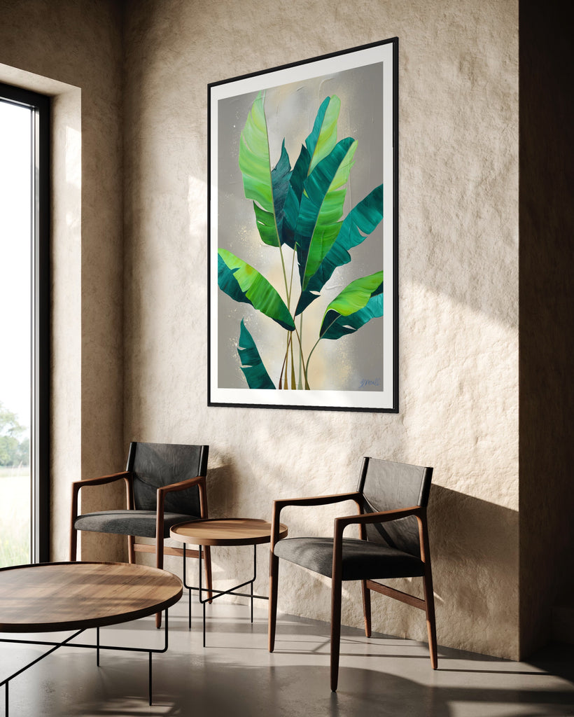 ‘Rainforest Glow' Fine Art Print by Jasmine Marshall, framed in black/oak. Premium Giclée print features green palm leaves on a neutral abstract painting. Displayed in a neutral home interior with two chairs.