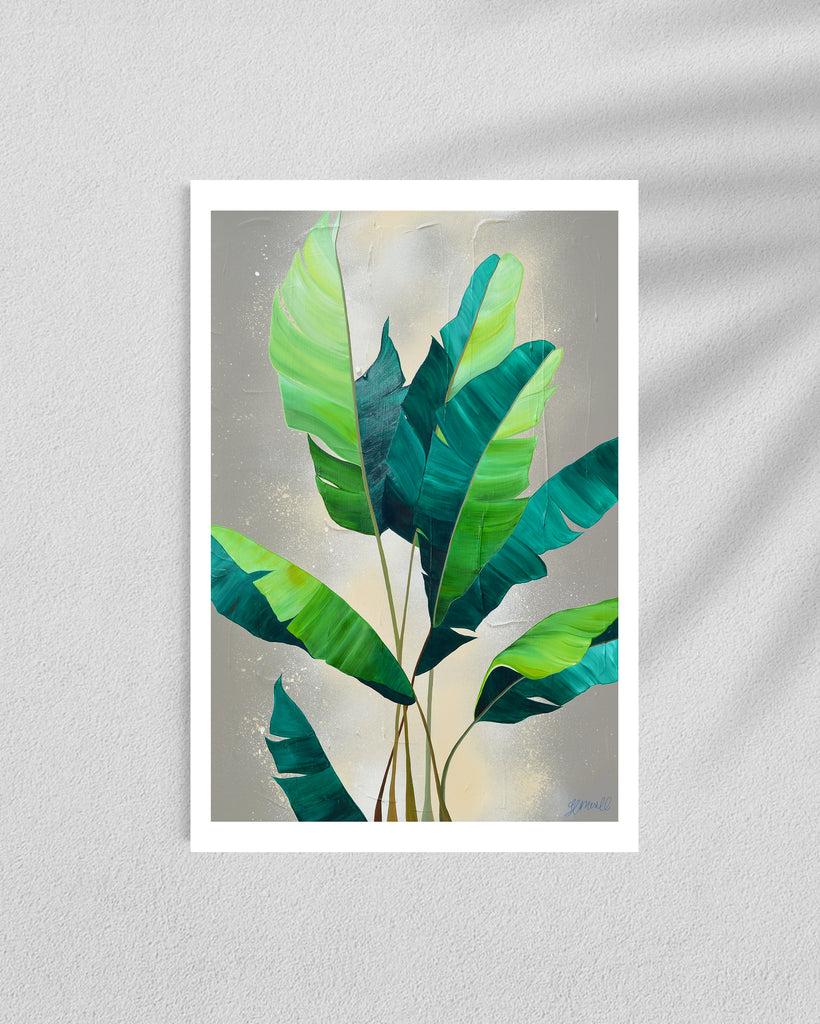 ‘Rainforest Glow' Fine Art Print by Jasmine Marshall, framed in black/oak. Premium Giclée print features green palm leaves on a neutral abstract painting. Displayed in a gallery.