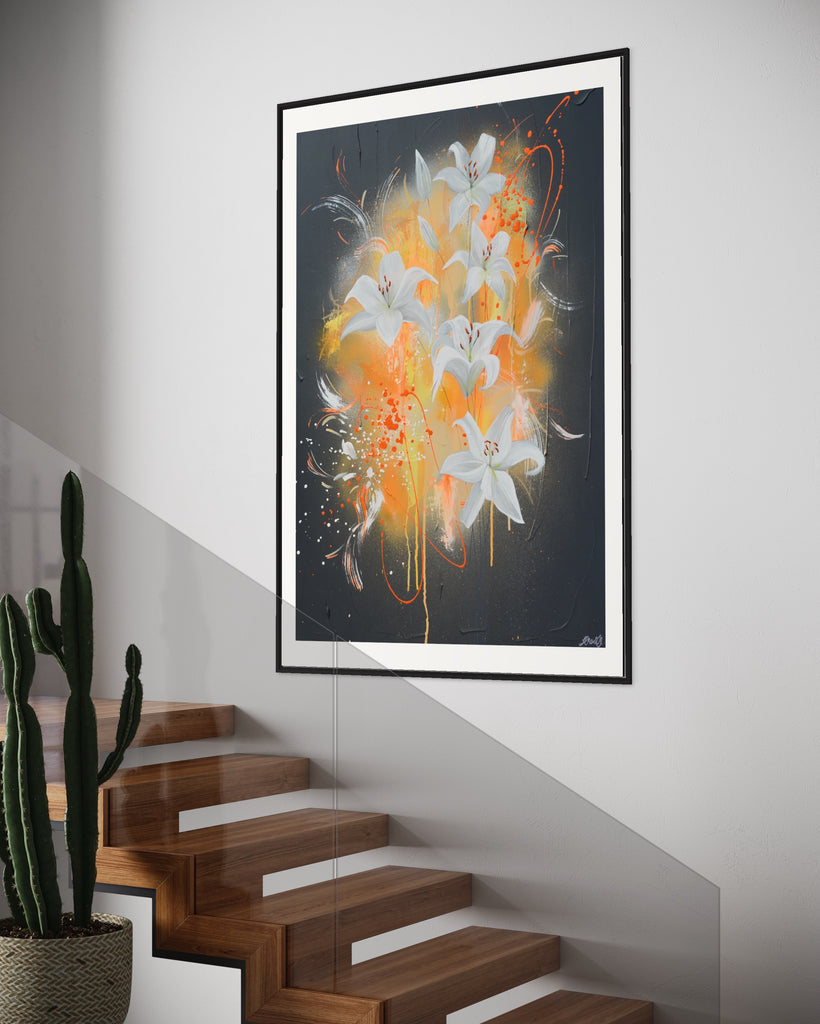 ‘Sweet Pollen' Fine Art Print by Jasmine Marshall, framed in black/oak. Premium Giclée print features white lilies on a grey textured background with pops of neon orange. Displayed above a wooden staircase with a cactus plant.