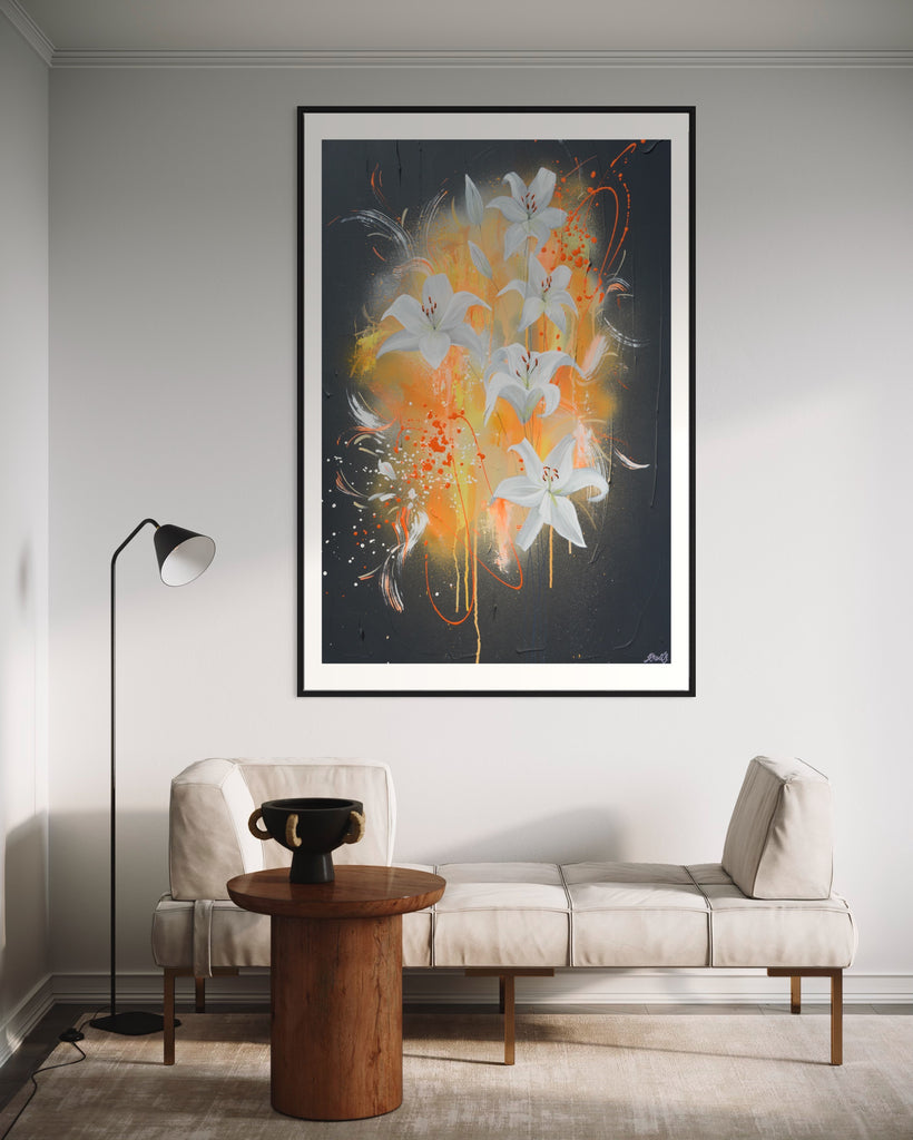 ‘Sweet Pollen' Fine Art Print by Jasmine Marshall, framed in black/oak. Premium Giclée print features white lilies on a grey textured background with pops of neon orange. Displayed in a neutral home interior.