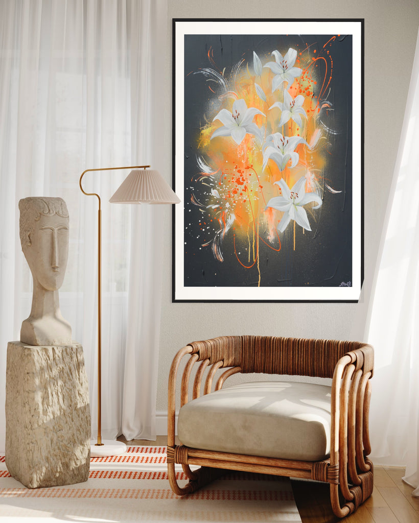 ‘Sweet Pollen' Fine Art Print by Jasmine Marshall, framed in black/oak. Premium Giclée print features white lilies on a grey textured background with pops of neon orange. Displayed in a neutral home interior with wooden chair and white curtains.