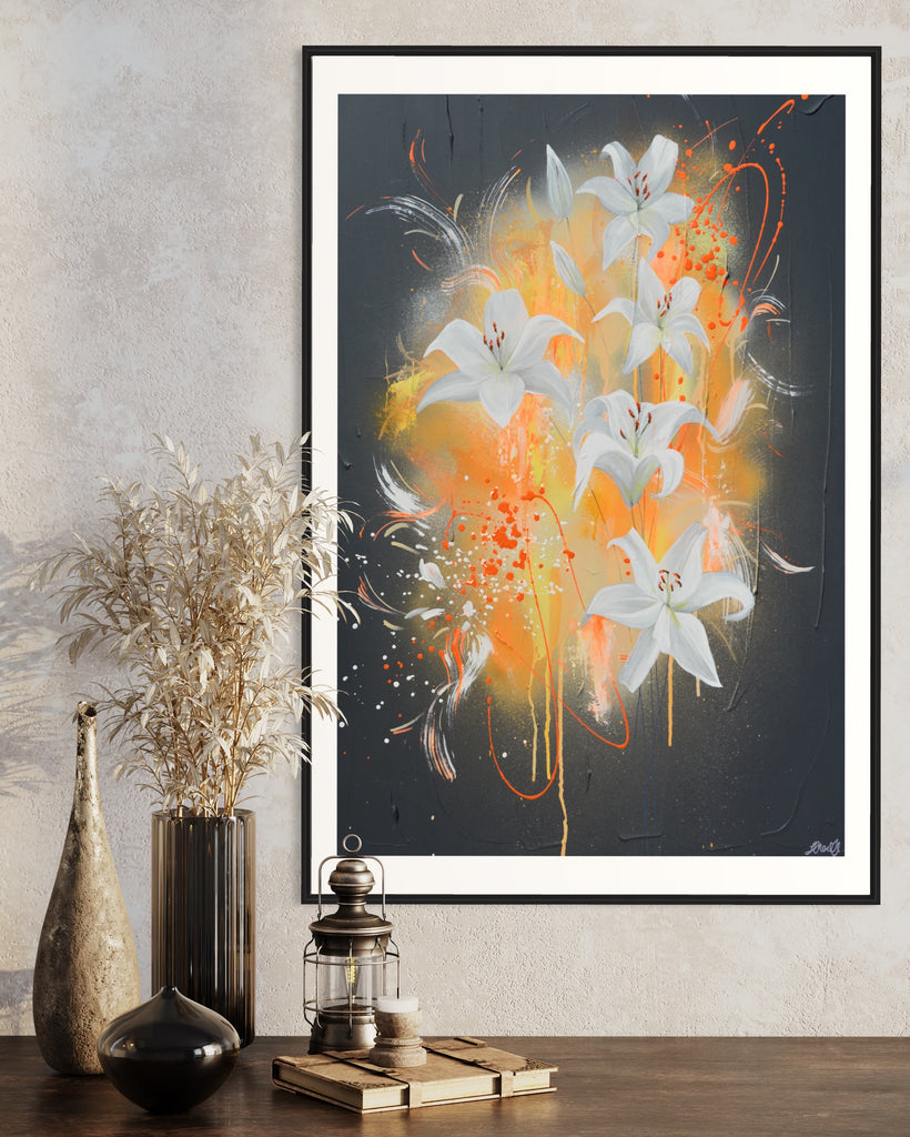 ‘Sweet Pollen' Fine Art Print by Jasmine Marshall, framed in black/oak. Premium Giclée print features white lilies on a grey textured background with pops of neon orange. Displayed in a neutral home interior on a wooden shelf with dried flowers.