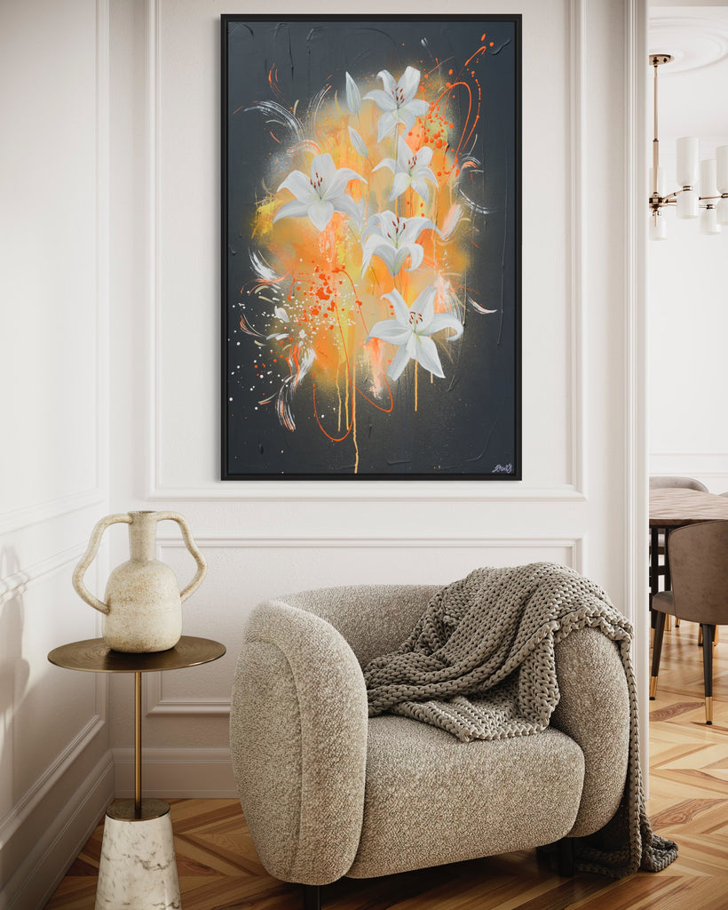 'Sweet Pollen' original painting on a cotton canvas by Jasmine Marshall, framed in black/oak. Features white lilies on a grey textured background with pops of neon orange. Displayed in a neutral home interior.