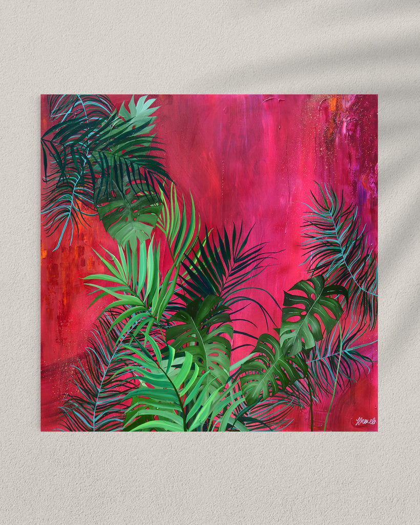 'The Foliage' original painting on a cotton canvas by Jasmine Marshall, framed in black/oak. Features tropical leaves over an abstract pink, red and orange painting Displayed in a gallery.