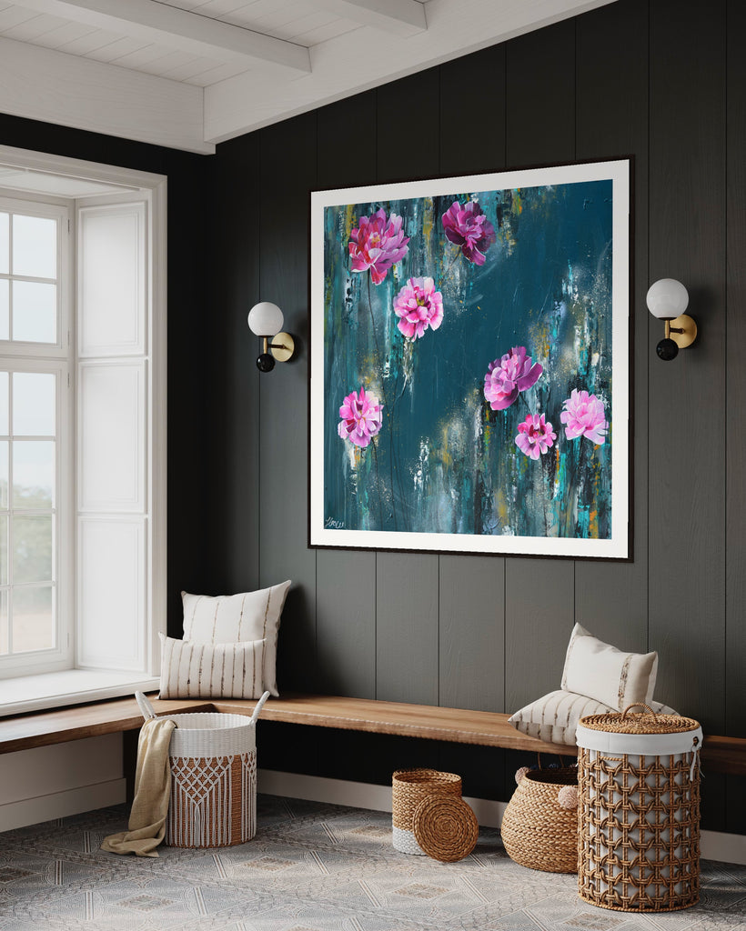 ‘The Other Side' Fine Art Print by Jasmine Marshall, framed in black/oak. Premium Giclée print features pink peonies on a teal background. Displayed on a grey wall with wooden bench and cream cushions.