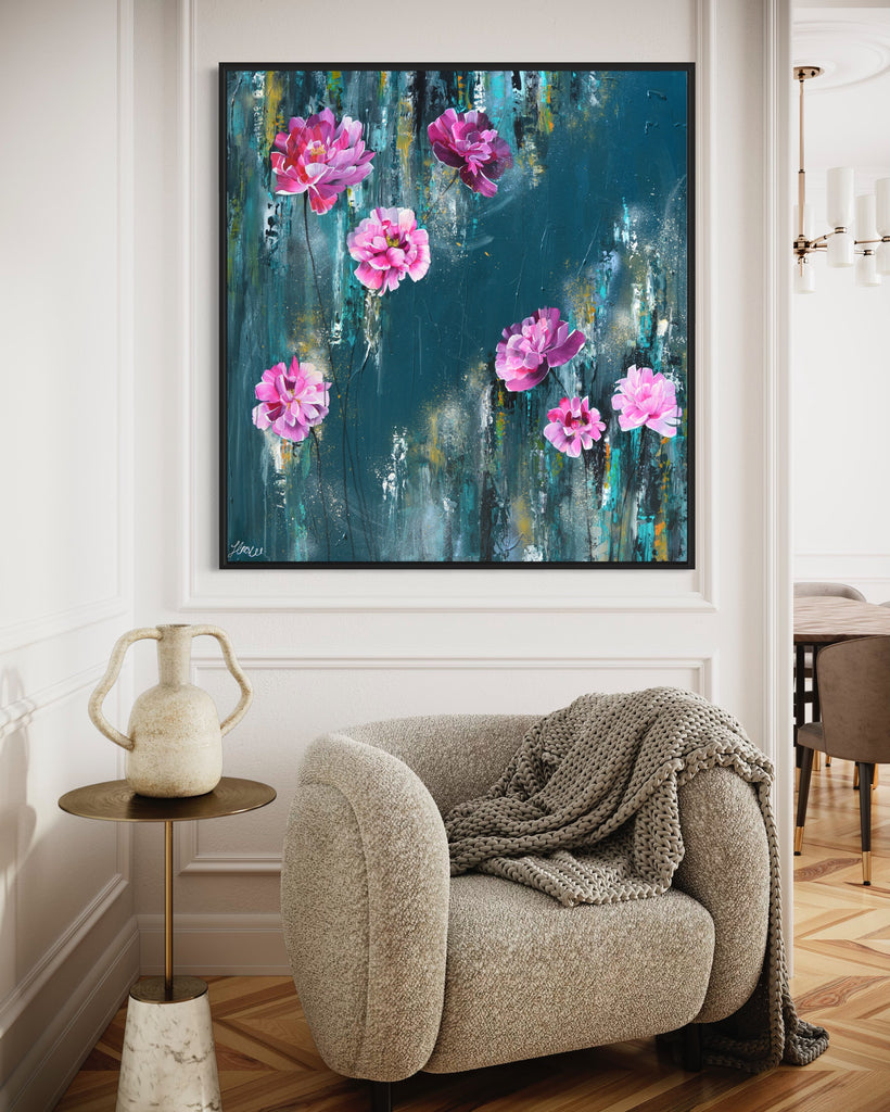 'The Other Side' original painting on a cotton canvas by Jasmine Marshall, framed in black/oak. Features pink peonies on a teal background. Displayed in a neutral home interior.