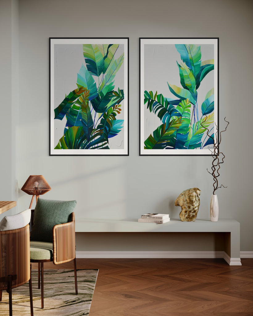 ‘Tropic Duo' Fine Art Print by Jasmine Marshall, framed in black/oak. Premium Giclée print features tropical blue and green leaves on a grey background. Displayed in a neutral home interior living room