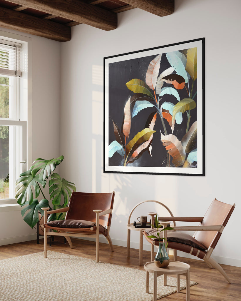 ‘Under the Canopy' Fine Art Print by Jasmine Marshall, framed in black/oak. Premium Giclée print features a palm tree on a brown background with abstract details. Displayed in a living room with wooden ceiling beams, brown chairs and a green plant.