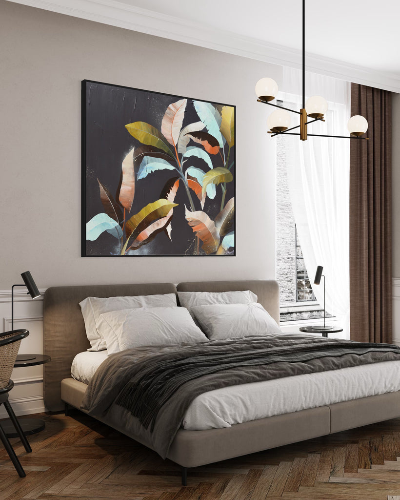 'Under the Canopy' original painting on a cotton canvas by Jasmine Marshall, framed in black/oak. Features a palm tree on a brown background with abstract details. Displayed in a neutral home interior in a bedroom with grey bedding.