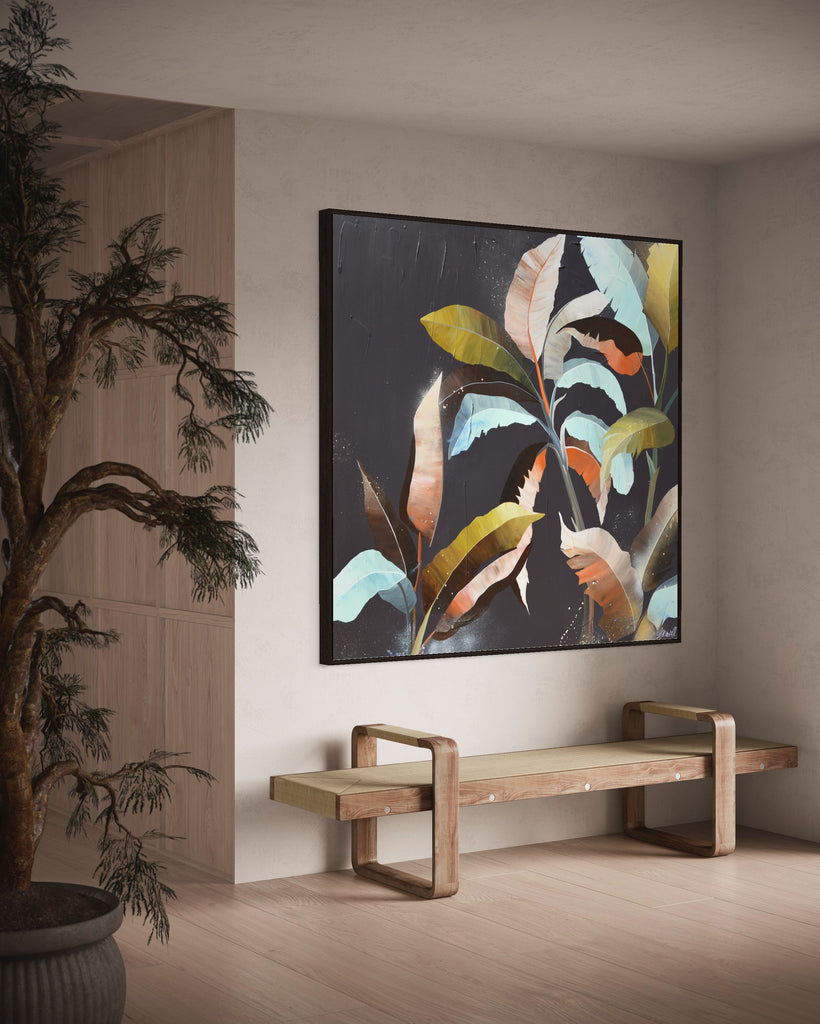 'Under the Canopy' original painting on a cotton canvas by Jasmine Marshall, framed in black/oak. Features a palm tree on a brown background with abstract details. Displayed in a neutral home interior with a wooden bench and plant.