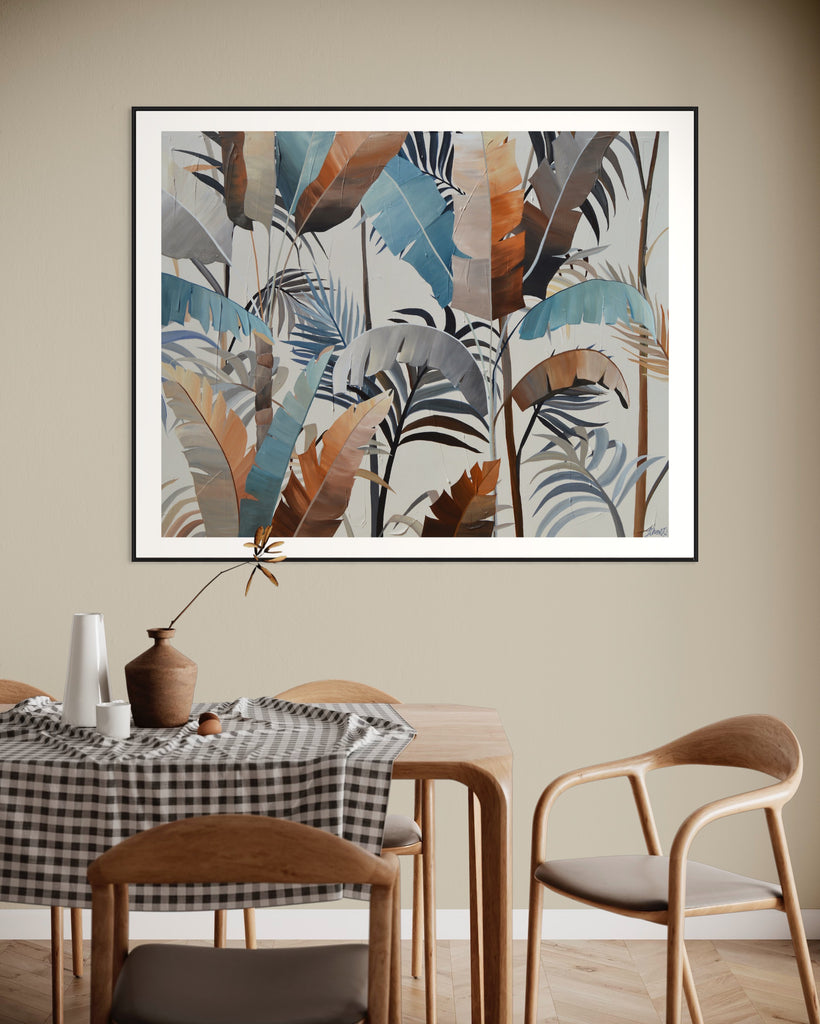 ‘Virgin Forest' Fine Art Print by Jasmine Marshall, framed in black/oak. Premium Giclée print features brown, blue, black leaves on a neutral background. Displayed in a neutral home interior with a wooden dining table.