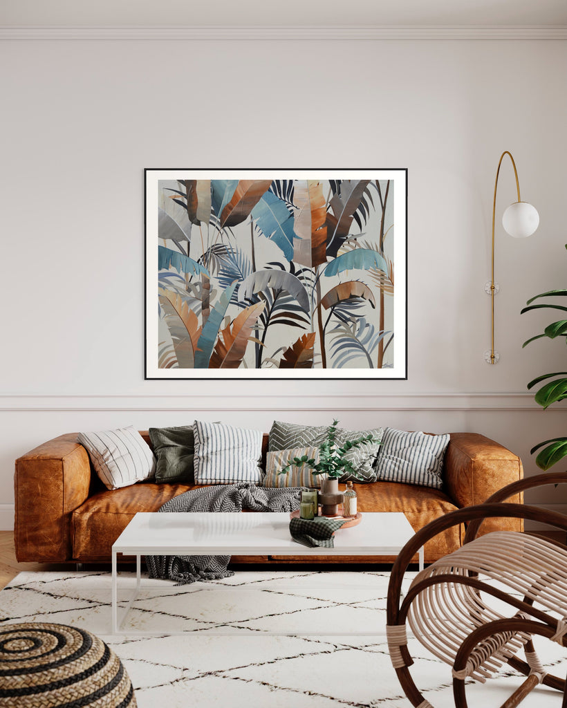 ‘Virgin Forest' Fine Art Print by Jasmine Marshall, framed in black/oak. Premium Giclée print features brown, blue, black leaves on a neutral background. Displayed in a neutral living room with a brown sofa, white rug and green plant.