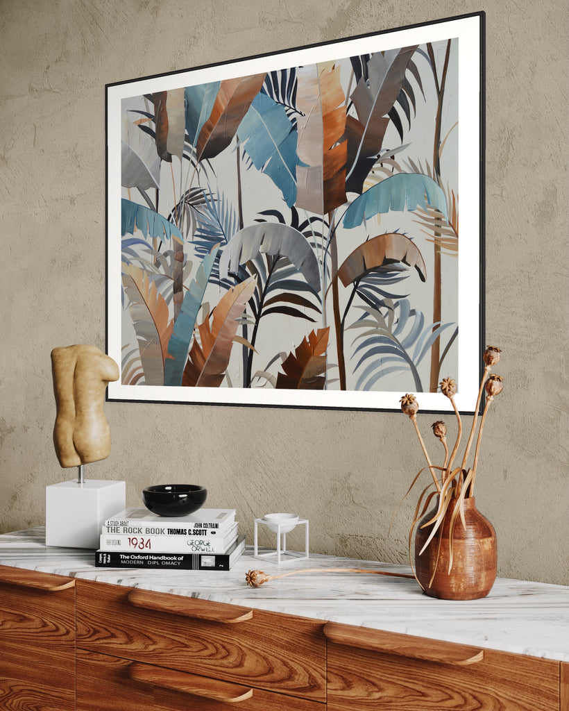 ‘Virgin Forest' Fine Art Print by Jasmine Marshall, framed in black/oak. Premium Giclée print features brown, blue, black leaves on a neutral background. Displayed in a neutral home interior above a wooden unit with dried flowers on.