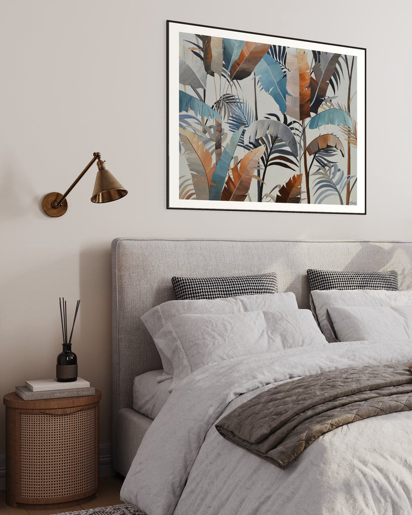 ‘Virgin Forest' Fine Art Print by Jasmine Marshall, framed in black/oak. Premium Giclée print features brown, blue, black leaves on a neutral background. Displayed in a neutral home interior above a grey bed.