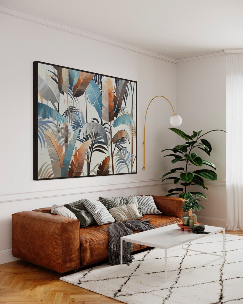 'Virgin Forest’ original painting on a cotton canvas by Jasmine Marshall, framed in black/oak. Features brown, blue, black leaves on a neutral background. Displayed in a neutral living room with a brown sofa, green plant, white rug.